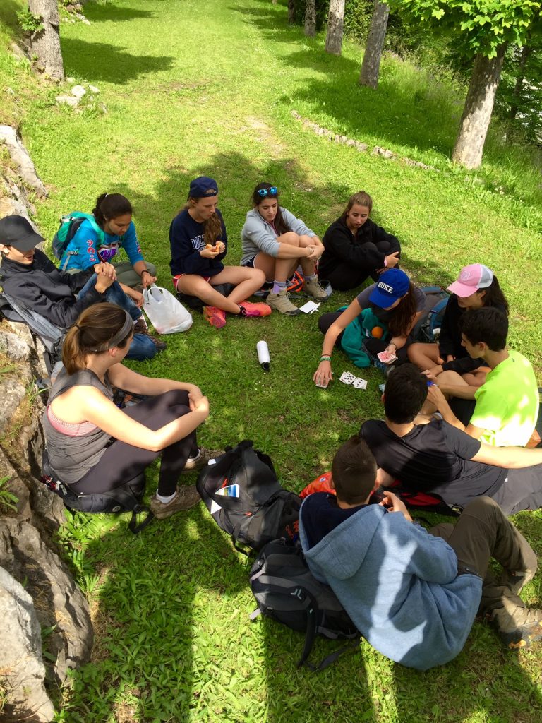 A circle of snacks and games on one of the terraces of mountain town Leysin!