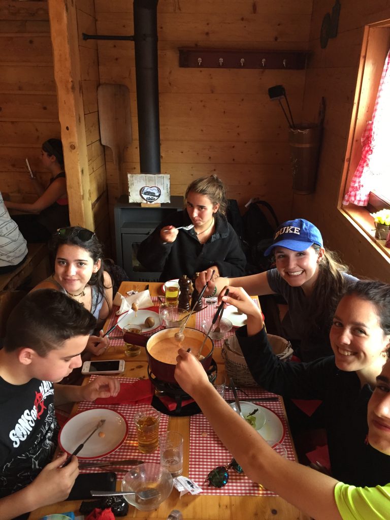 The gang loving traditional Swiss fondue at La Prafondaz, part deux!